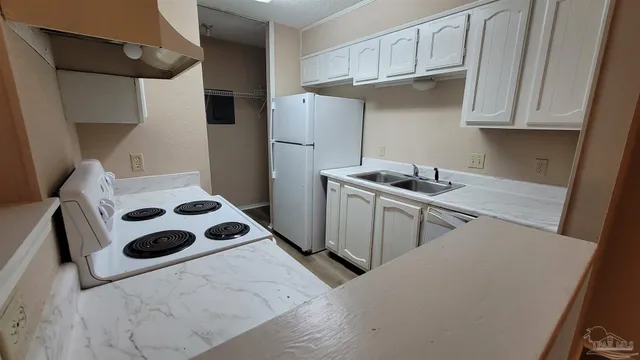 a kitchen with stainless steel appliances kitchen island a sink a stove and refrigerator