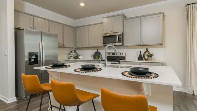 a kitchen with a stove a sink and a refrigerator