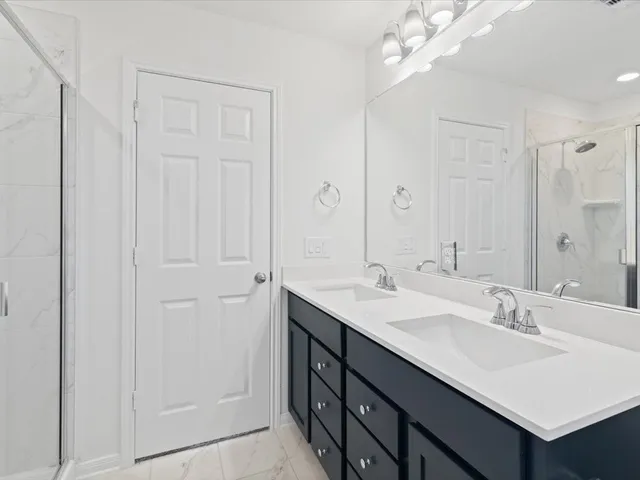 a bathroom with 2 sink and a mirror