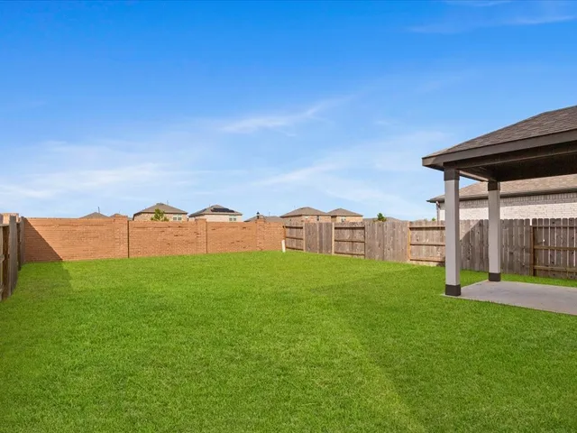 a view of a house with a yard and a garden