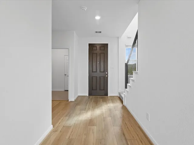 a view of hallway with wooden floor