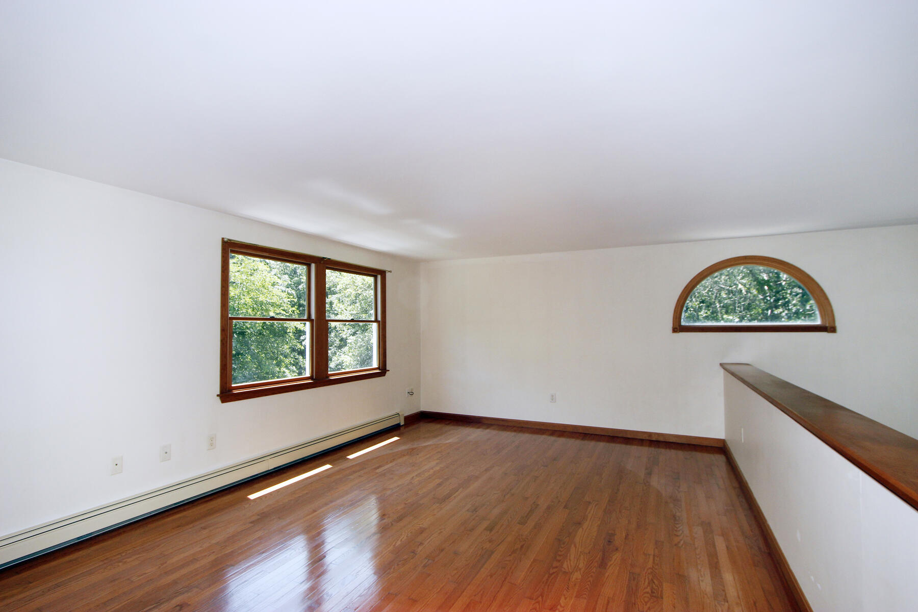495 Aspinet Road Eastham, MA 02642 - Photo 5 of 47 an empty room with wooden floor and windows