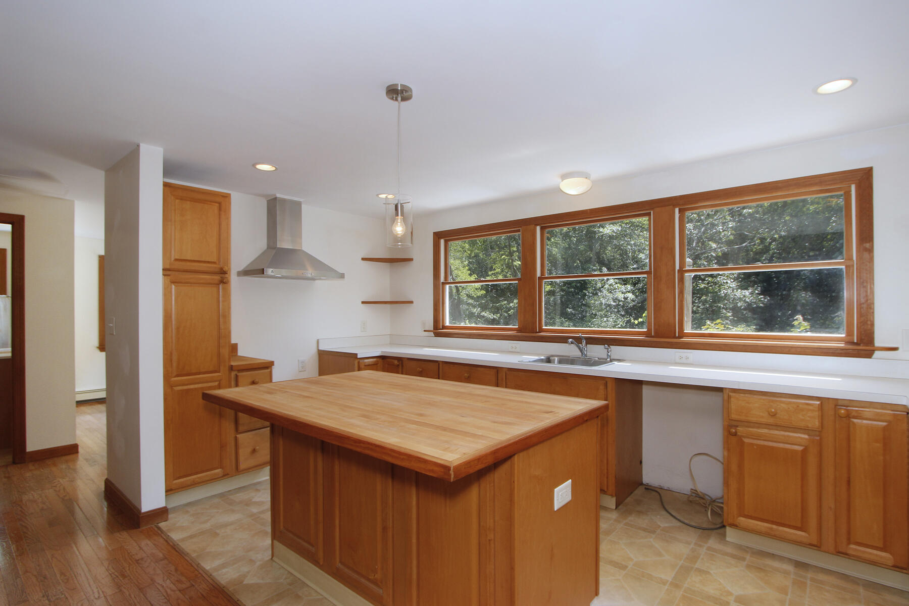 495 Aspinet Road Eastham, MA 02642 - Photo 8 of 47 a kitchen that has a lot of cabinets in it and wooden floors