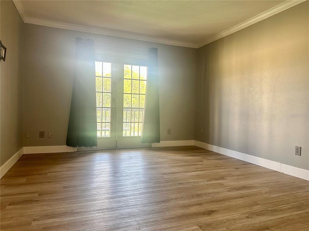 435 Wymore Road, Unit 207 Altamonte Springs, FL 32714 - Photo 2 of 17 a view of an empty room with wooden floor and a window