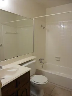 a bathroom with a sink a toilet and a shower