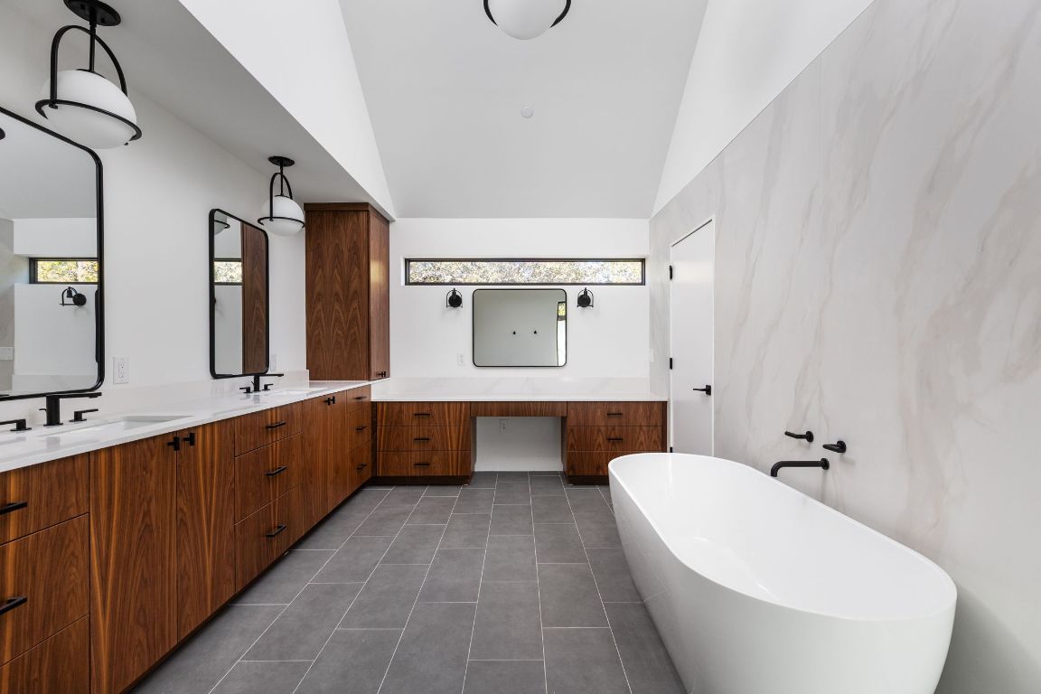 1603 Chelsea Lane, Unit 1 Austin, TX 78704 - Photo 20 of 40 Bathroom with double vanity, a freestanding tub, and dark tile patterned flooring