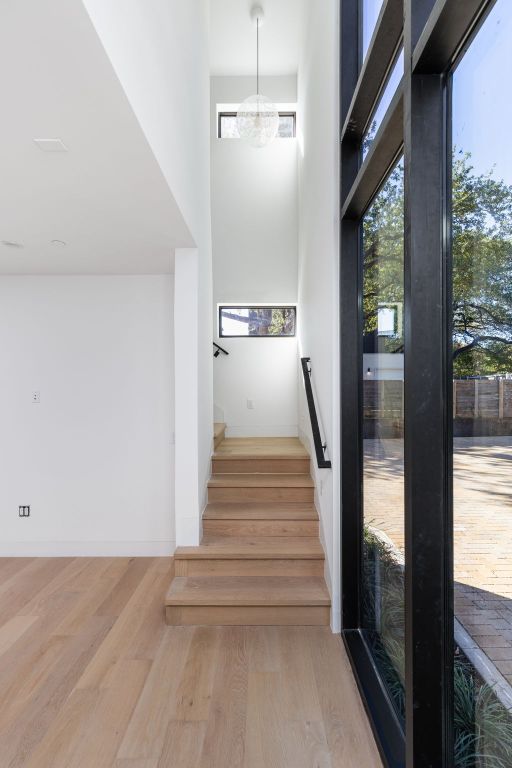 1603 Chelsea Lane, Unit 1 Austin, TX 78704 - Photo 25 of 40 Staircase with wood finished floors and a towering ceiling