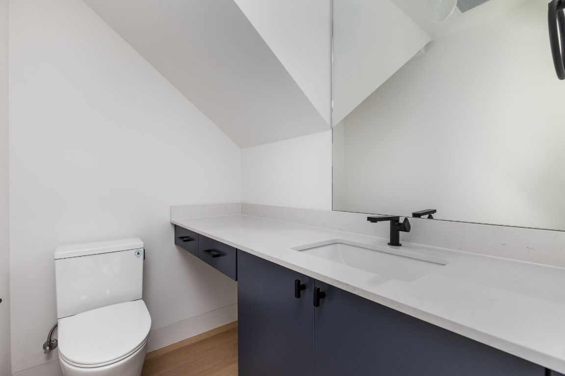 1603 Chelsea Lane, Unit 1 Austin, TX 78704 - Photo 27 of 40 Bathroom featuring vanity, light wood-style flooring, and lofted ceiling