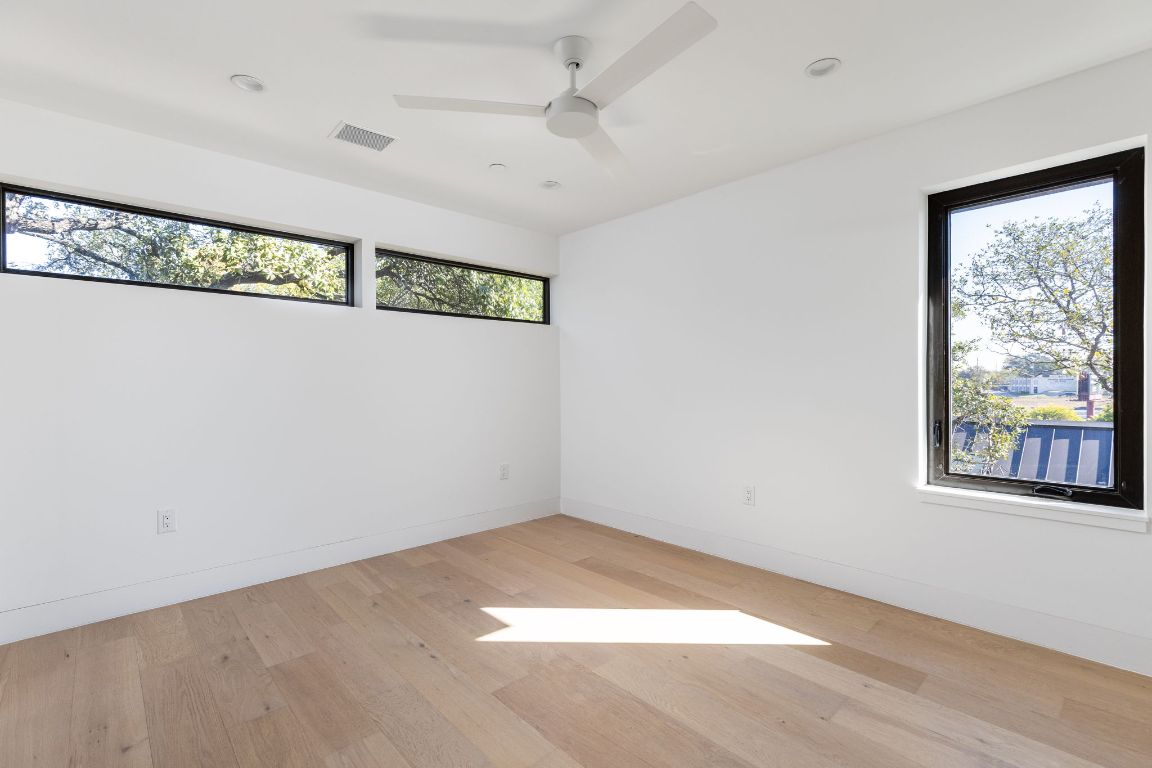 1603 Chelsea Lane, Unit 1 Austin, TX 78704 - Photo 28 of 40 Empty room with light wood-style flooring and a ceiling fan