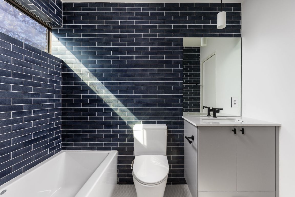1603 Chelsea Lane, Unit 1 Austin, TX 78704 - Photo 30 of 40 Full bathroom featuring vanity and tile walls