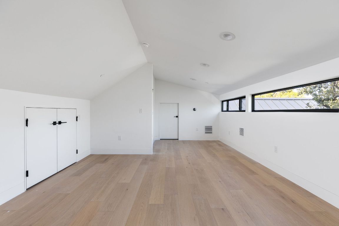 1603 Chelsea Lane, Unit 1 Austin, TX 78704 - Photo 31 of 40 Bonus room with light wood-style flooring and lofted ceiling
