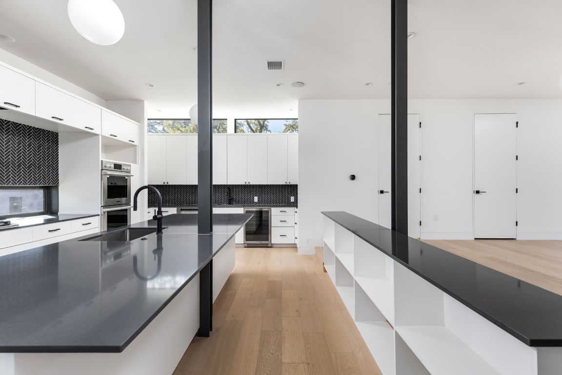 1603 Chelsea Lane, Unit 1 Austin, TX 78704 - Photo 9 of 40 Kitchen with open shelves, white cabinetry, light wood-style floors, and wine cooler