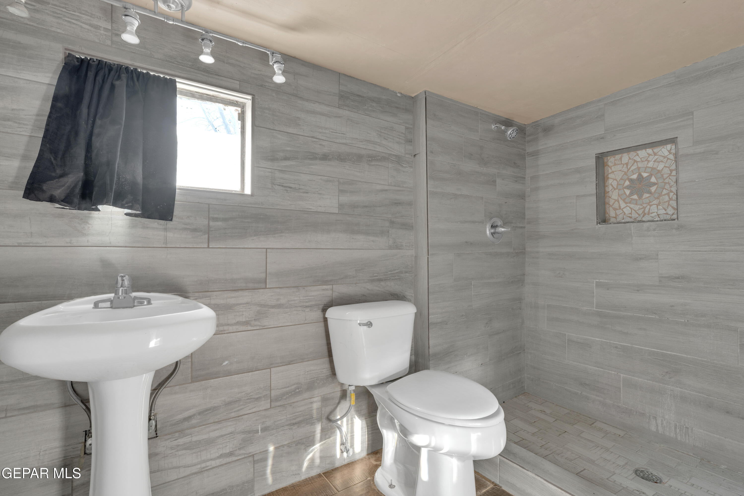 10184 Haynes Road Socorro, TX 79927 - Photo 6 of 25 a bathroom with a toilet sink and mirror