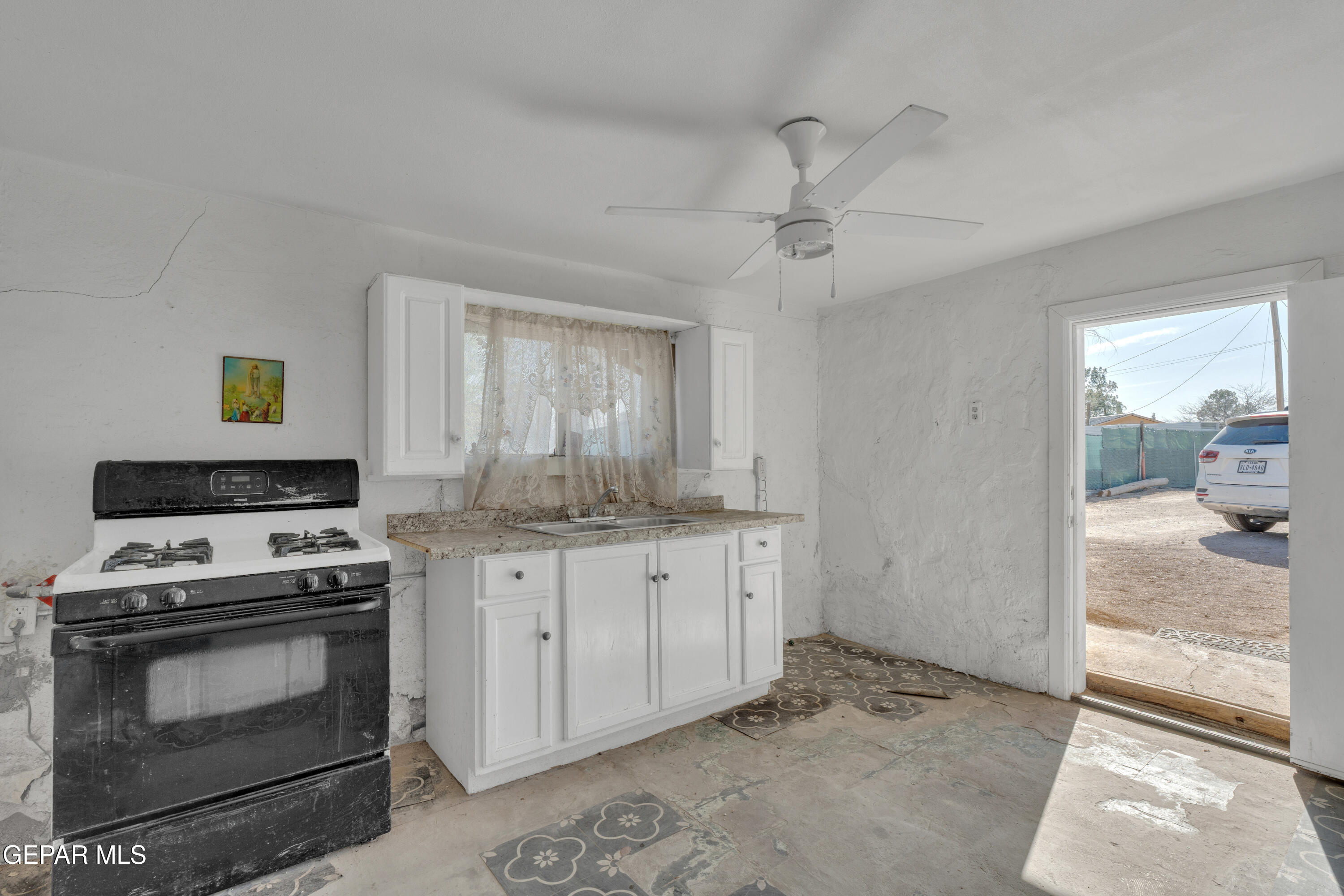 10184 Haynes Road Socorro, TX 79927 - Photo 10 of 25 a kitchen with granite countertop a stove sink and cabinets