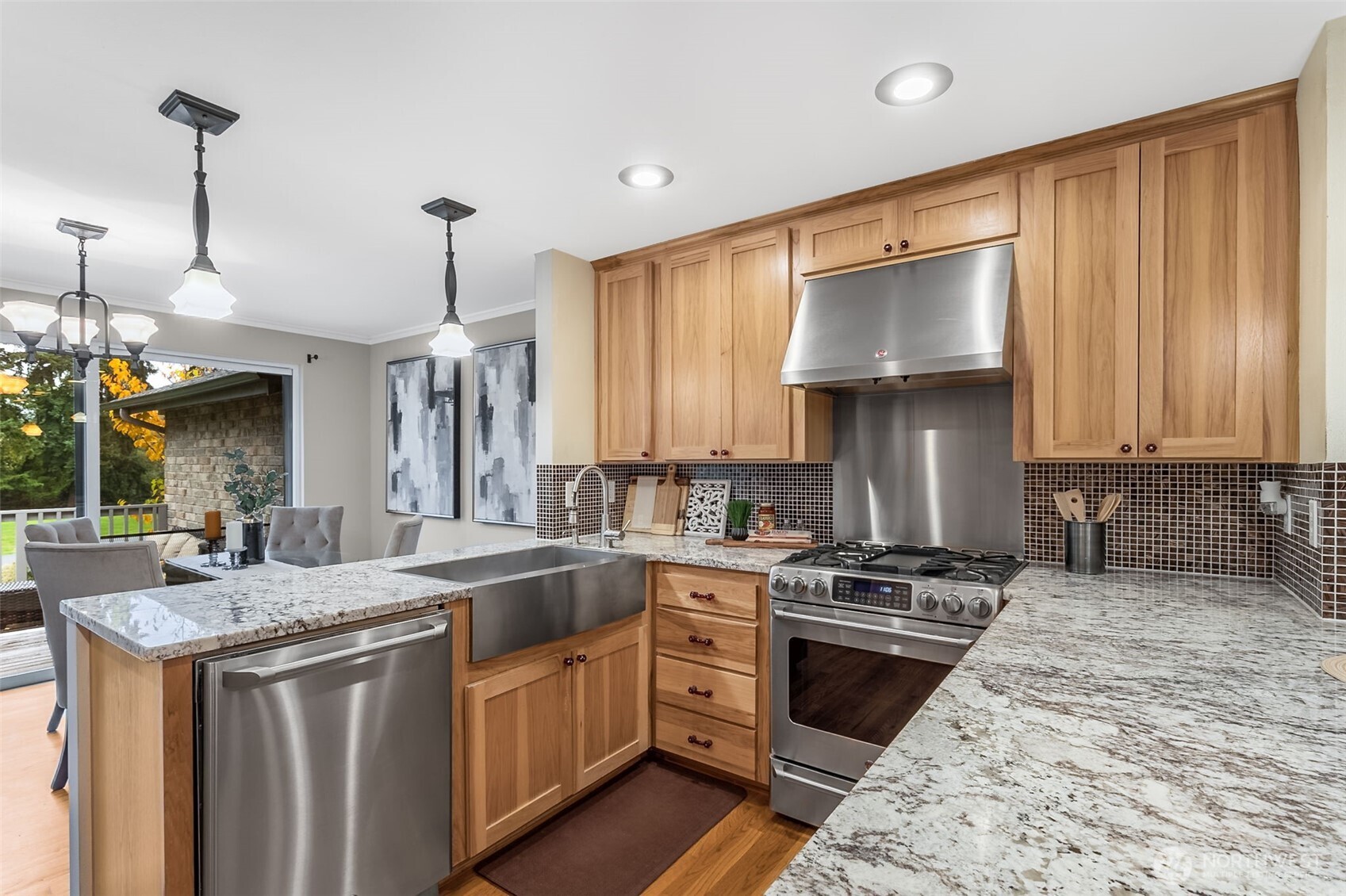 6524 Northeast 171st Place Kenmore, WA 98028 - Photo 11 of 35 a kitchen with stainless steel appliances granite countertop a sink a stove and a wooden floors