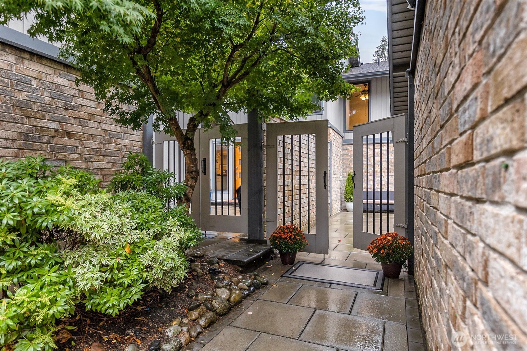 6524 Northeast 171st Place Kenmore, WA 98028 - Photo 2 of 35 a front view of a house with a garden