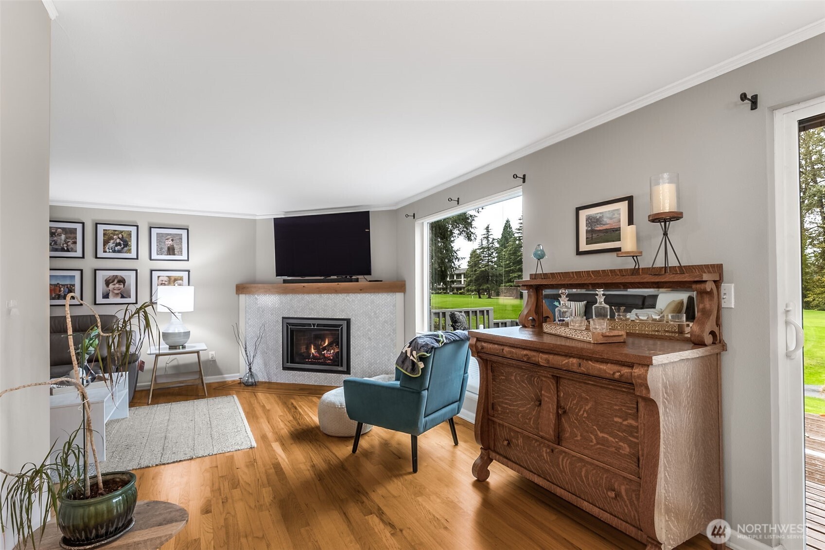 6524 Northeast 171st Place Kenmore, WA 98028 - Photo 7 of 35 a living room with furniture a flat screen tv and a fireplace
