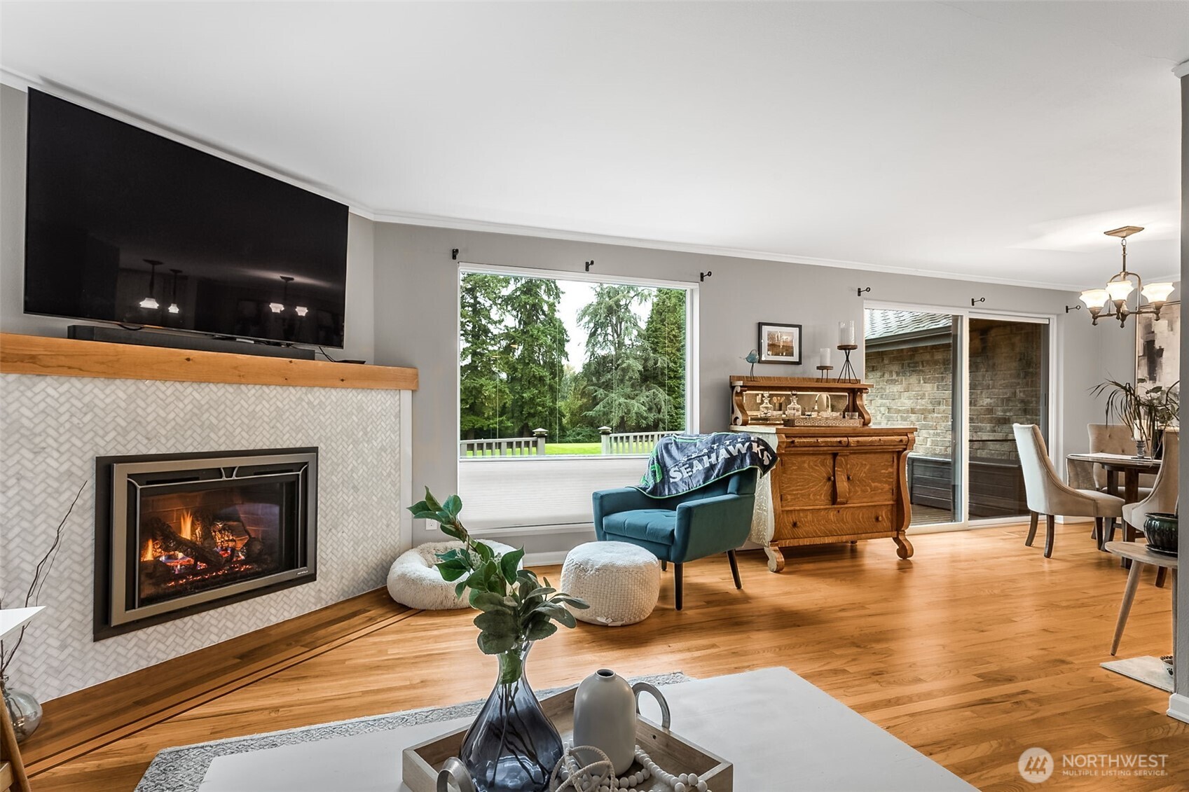 6524 Northeast 171st Place Kenmore, WA 98028 - Photo 8 of 35 a living room with furniture a flat screen tv and a fireplace