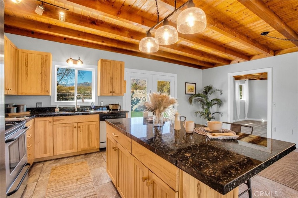 9384 Piedras Trail Morongo Valley, CA 92256 - Photo 16 of 75 a kitchen with stainless steel appliances granite countertop a sink stove and cabinets