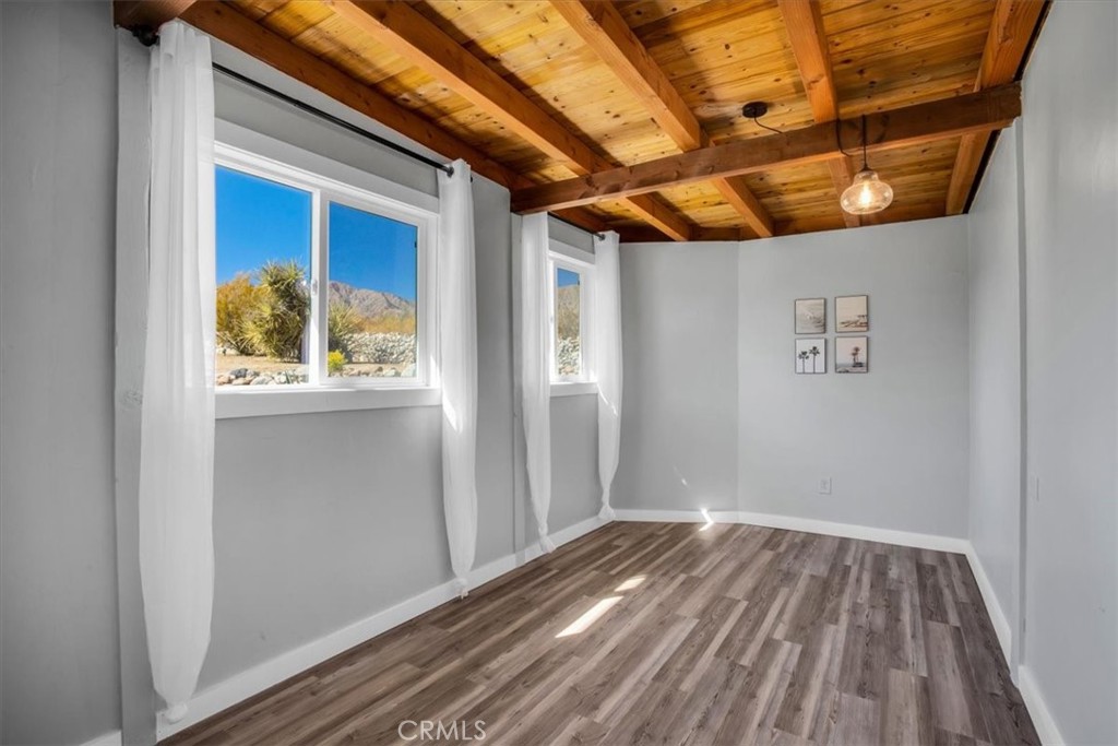 9384 Piedras Trail Morongo Valley, CA 92256 - Photo 19 of 75 a view of a hallway with wooden floor and a window