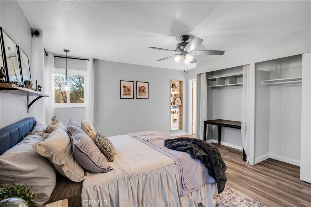 9384 Piedras Trail Morongo Valley, CA 92256 - Photo 21 of 75 a bedroom with a bed and a chandelier