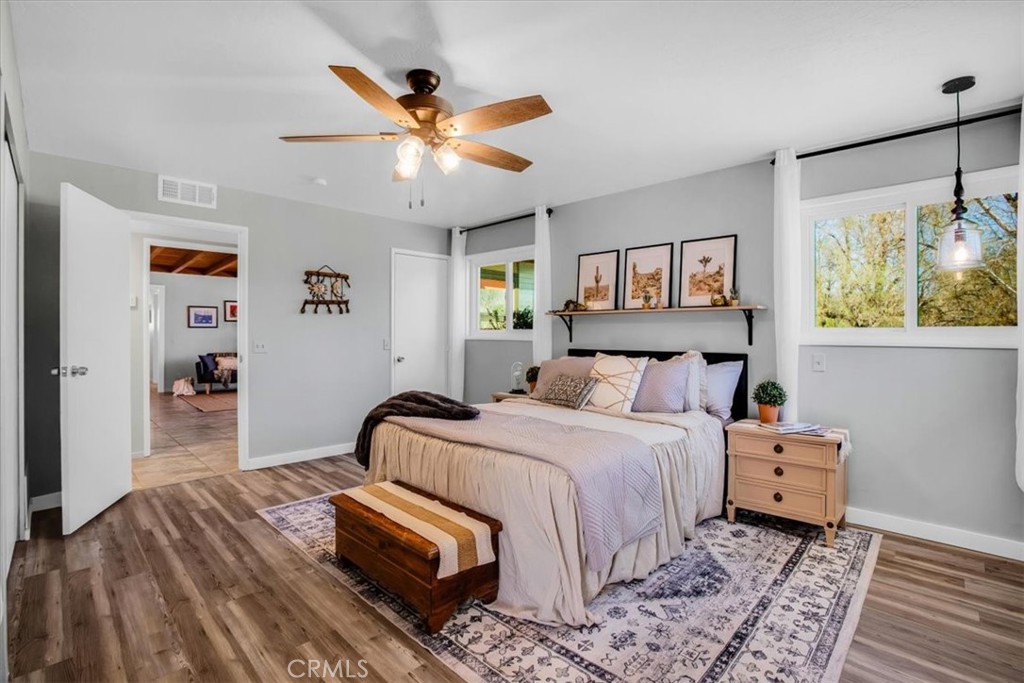 9384 Piedras Trail Morongo Valley, CA 92256 - Photo 22 of 75 a bedroom with a bed and a chandelier