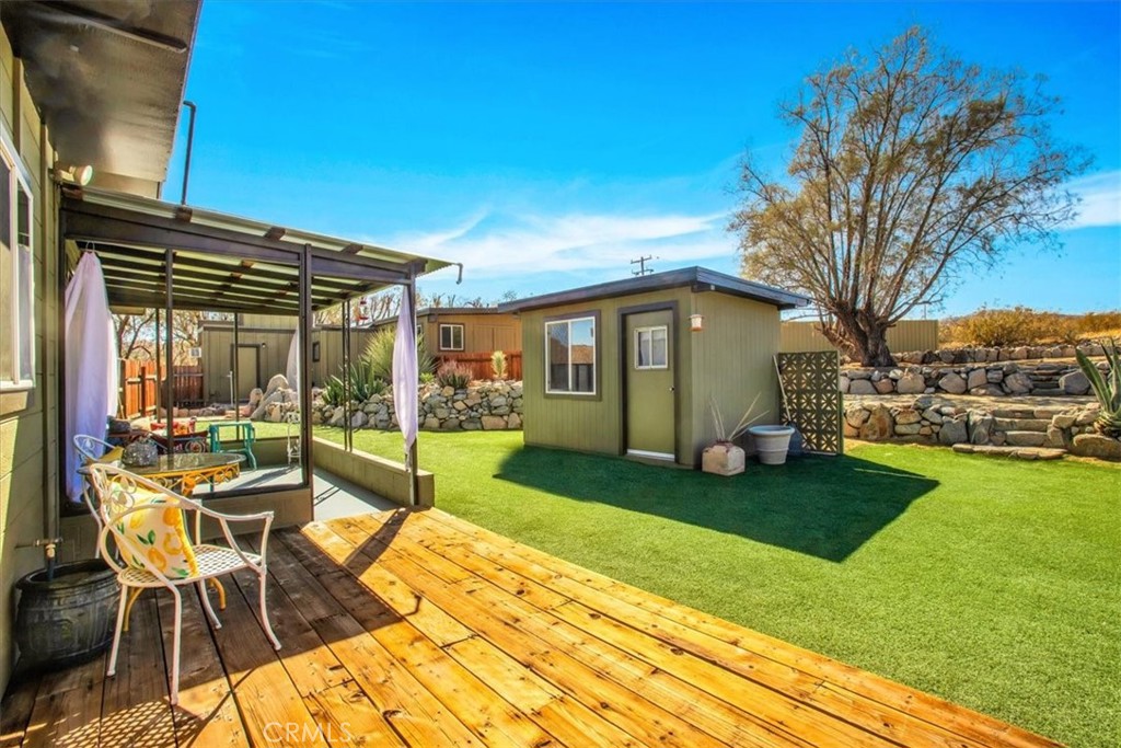 9384 Piedras Trail Morongo Valley, CA 92256 - Photo 29 of 75 a view of a house with backyard porch and garden