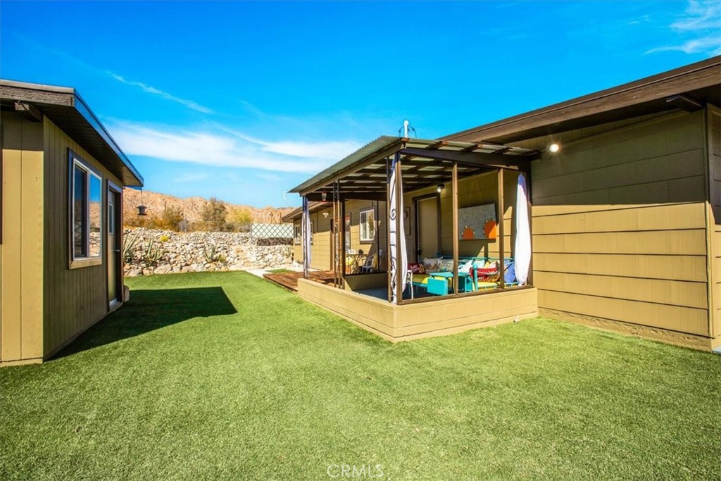 9384 Piedras Trail Morongo Valley, CA 92256 - Photo 32 of 75 a view of porch with a flat tv screen and a big yard