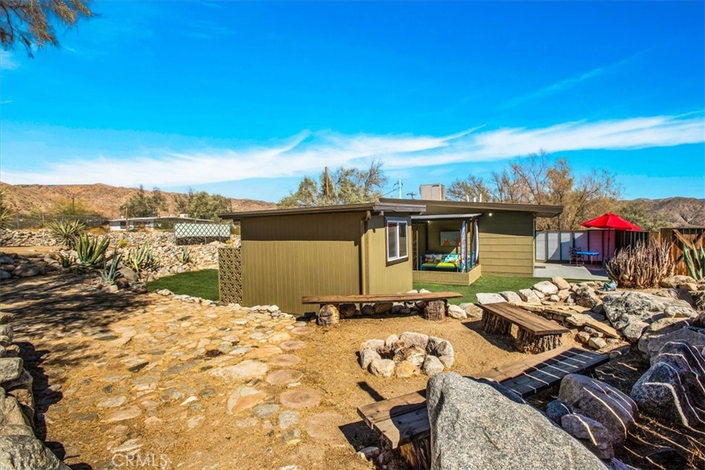 9384 Piedras Trail Morongo Valley, CA 92256 - Photo 38 of 75 a view of a terrace with furniture and a garden