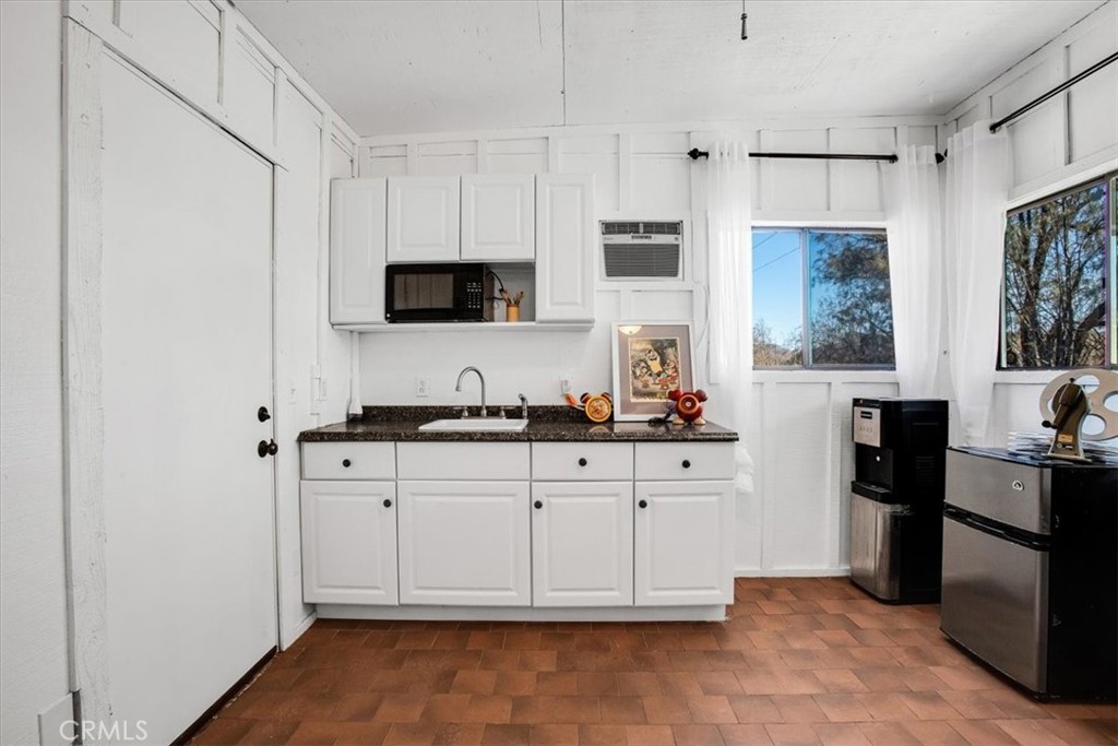 9384 Piedras Trail Morongo Valley, CA 92256 - Photo 45 of 75 a kitchen with granite countertop white cabinets and stainless steel appliances