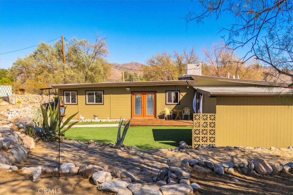 9384 Piedras Trail Morongo Valley, CA 92256 - Photo 53 of 75 a front view of a house with a yard