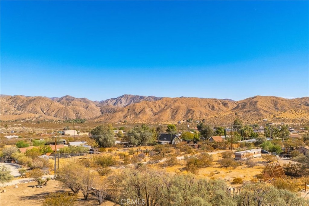 9384 Piedras Trail Morongo Valley, CA 92256 - Photo 57 of 75 a view of a mountain range in a cloudy sky