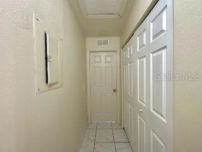 a view of a hallway with wooden floor and entryway