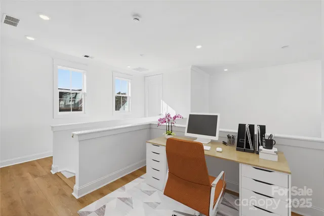 a workspace with a computer on a desk and chair
