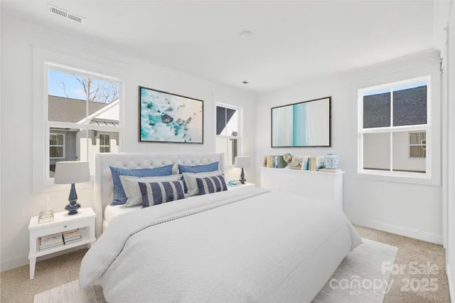 a bed room with a bed and a painting on the wall