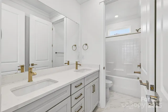 a bathroom with a sink and a mirror with bathtub