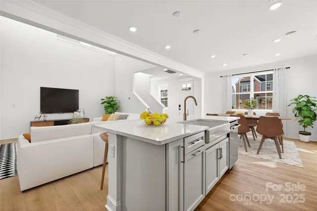a kitchen with stainless steel appliances kitchen island granite countertop a sink and a stove