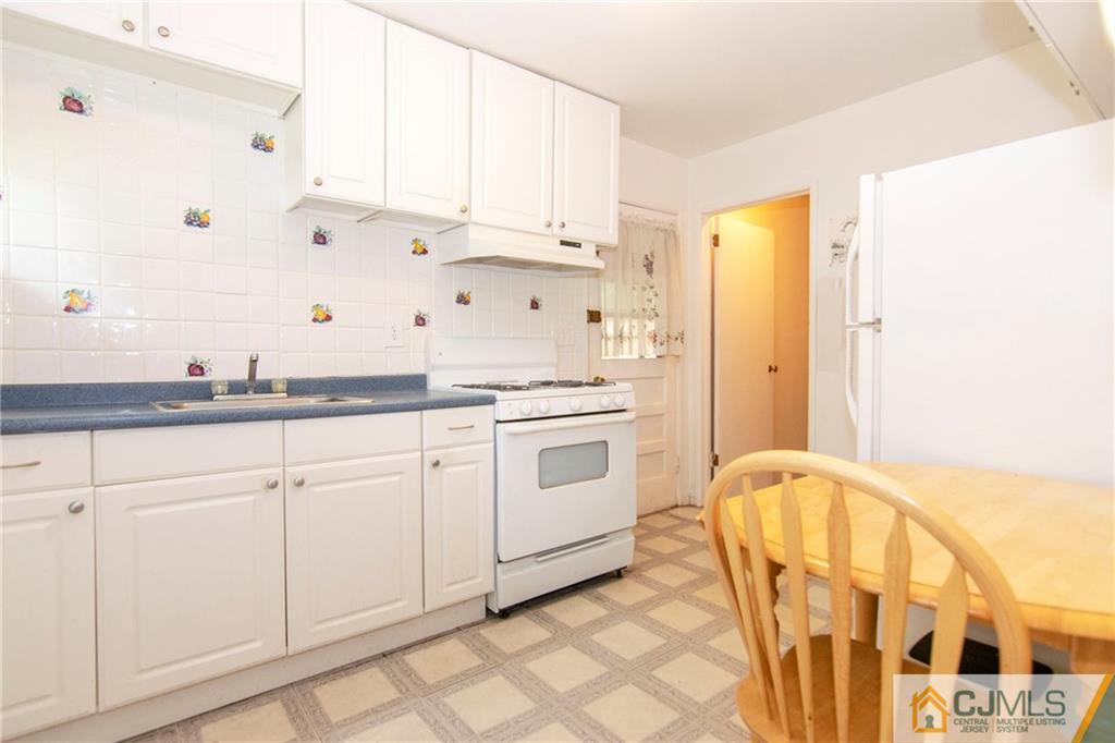 4 Harvard Road Old Bridge, NJ 08859 - Photo 3 of 18 a kitchen with granite countertop white cabinets and white appliances