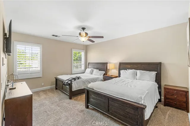 a bedroom with two beds and painting on the wall