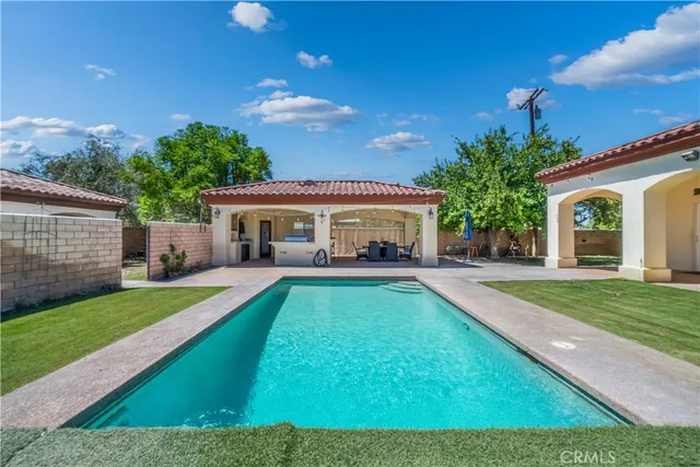 a view of house with a backyard