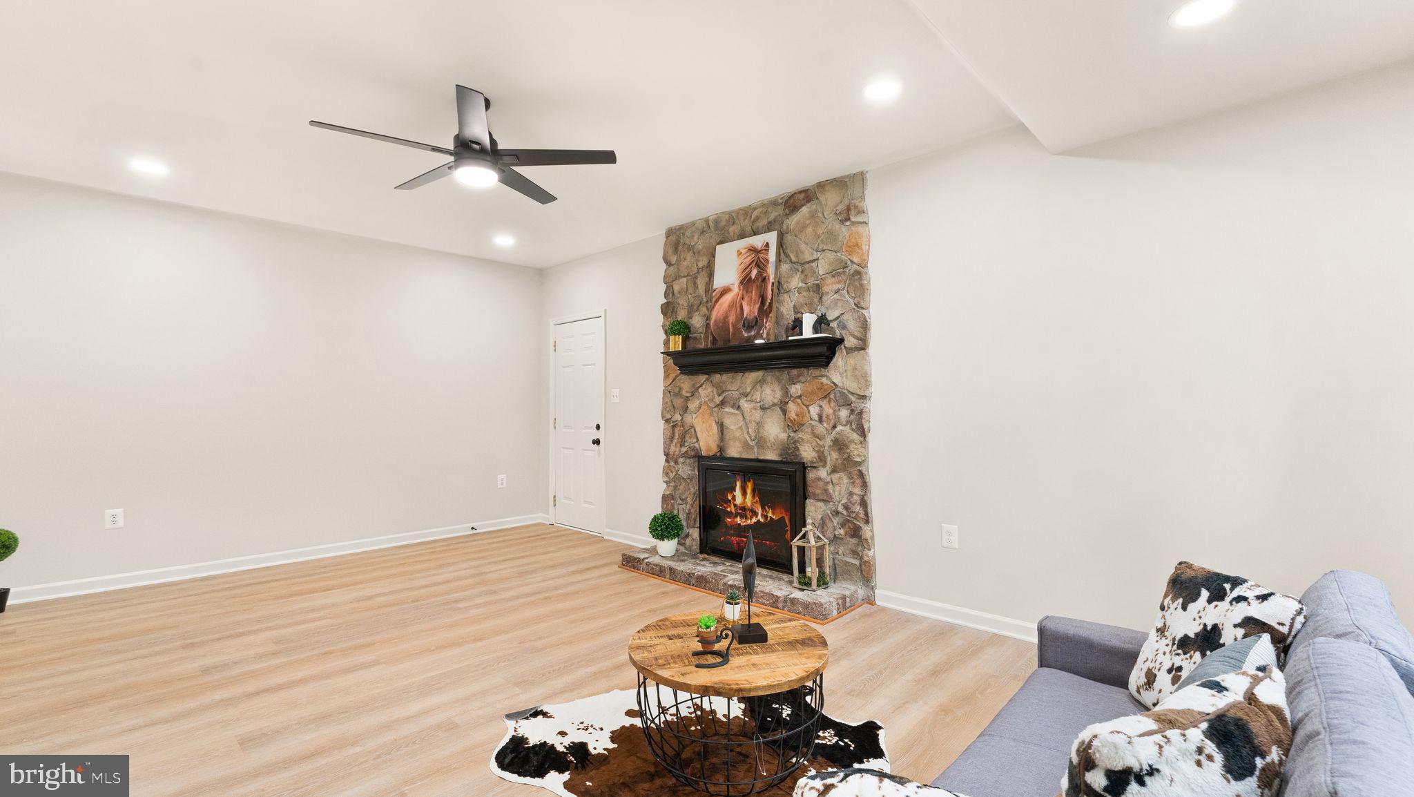 8309 Rolling Road Manassas, VA 20110 - Photo 16 of 70 a living room with furniture and a fireplace