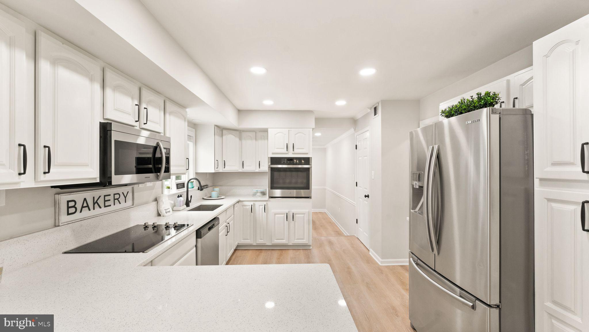 8309 Rolling Road Manassas, VA 20110 - Photo 25 of 70 a kitchen with stainless steel appliances a refrigerator and a sink