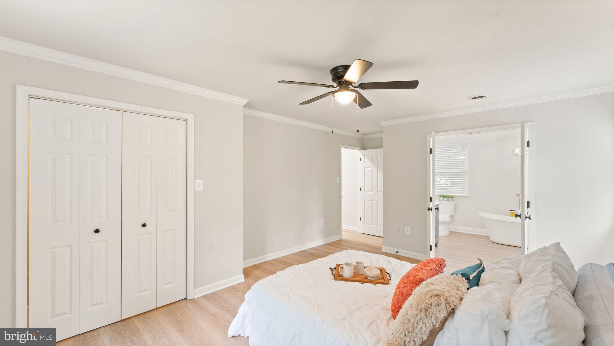 8309 Rolling Road Manassas, VA 20110 - Photo 43 of 70 a bedroom with a large bed and a chandelier