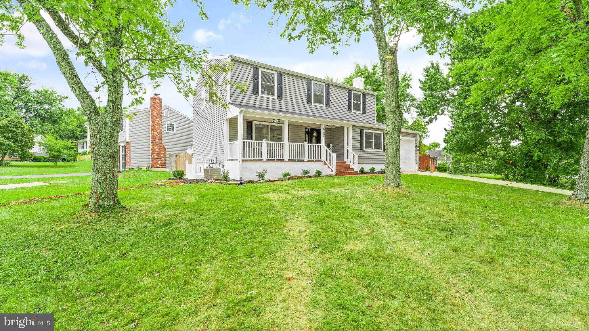 8309 Rolling Road Manassas, VA 20110 - Photo 5 of 70 a front view of a house with a yard and trees