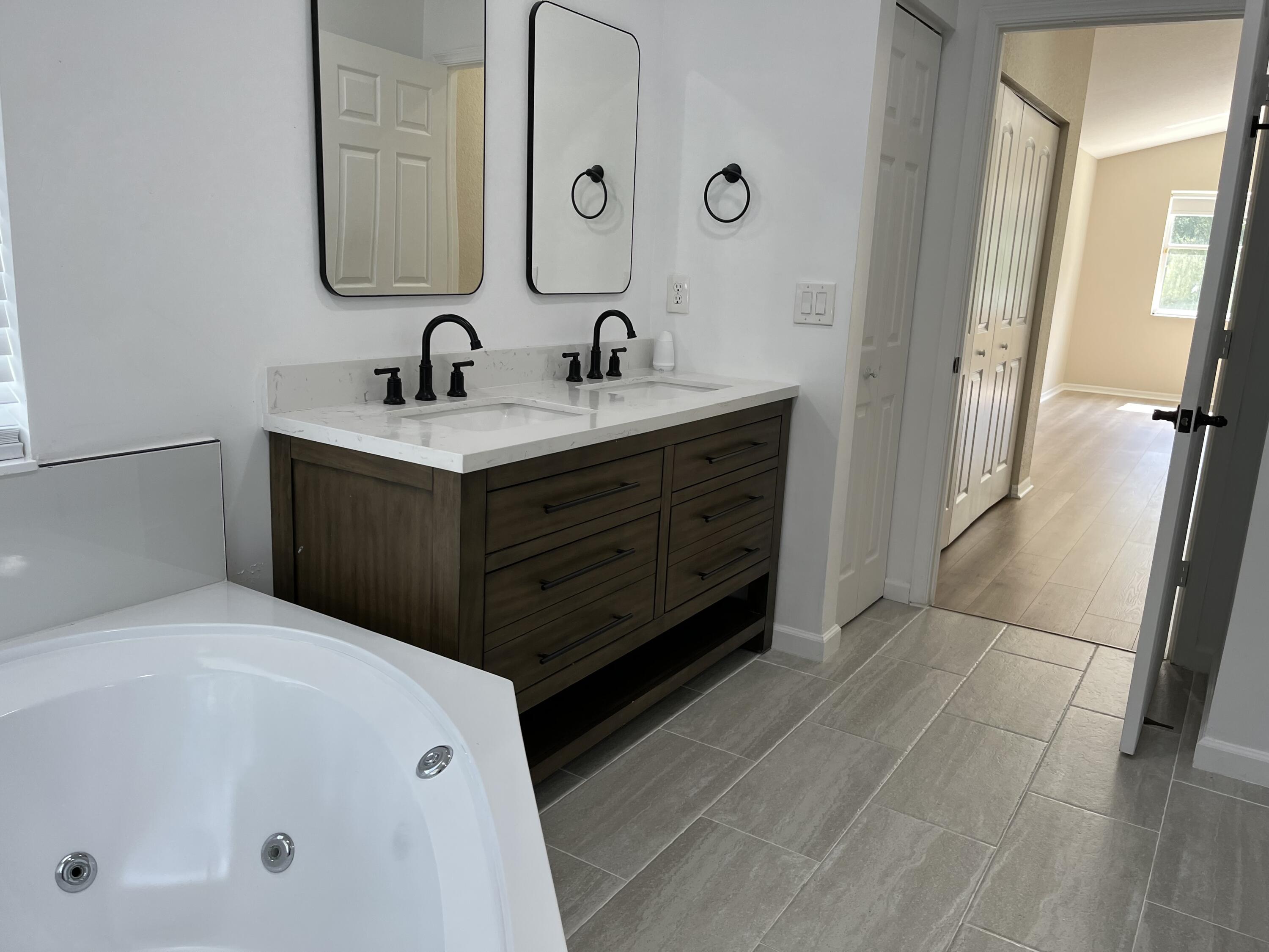 7299 Panache Way Boca Raton, FL 33433 - Photo 11 of 16 a bathroom with a double vanity sink and mirror