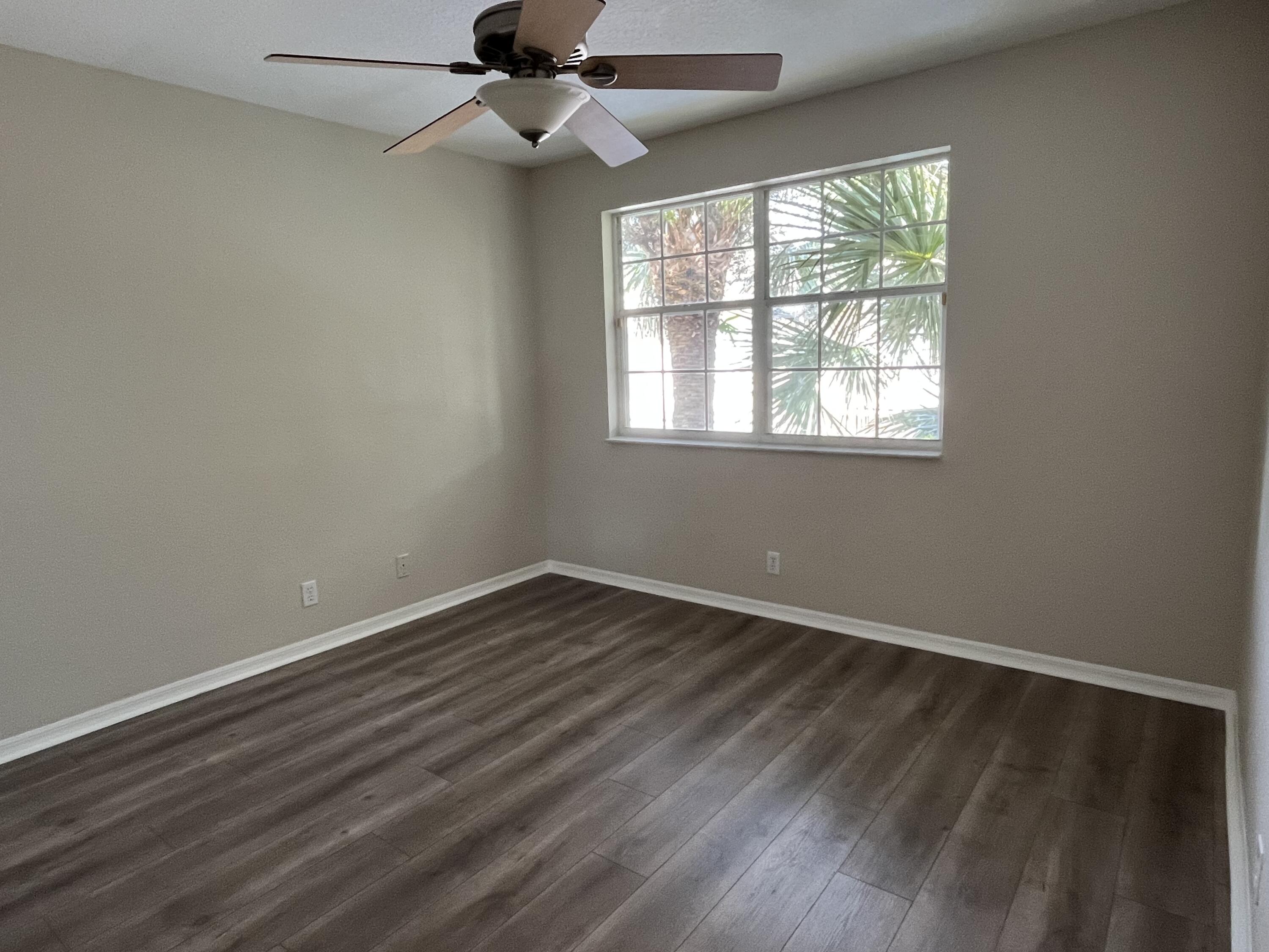 7299 Panache Way Boca Raton, FL 33433 - Photo 12 of 16 an empty room with wooden floor fan and windows