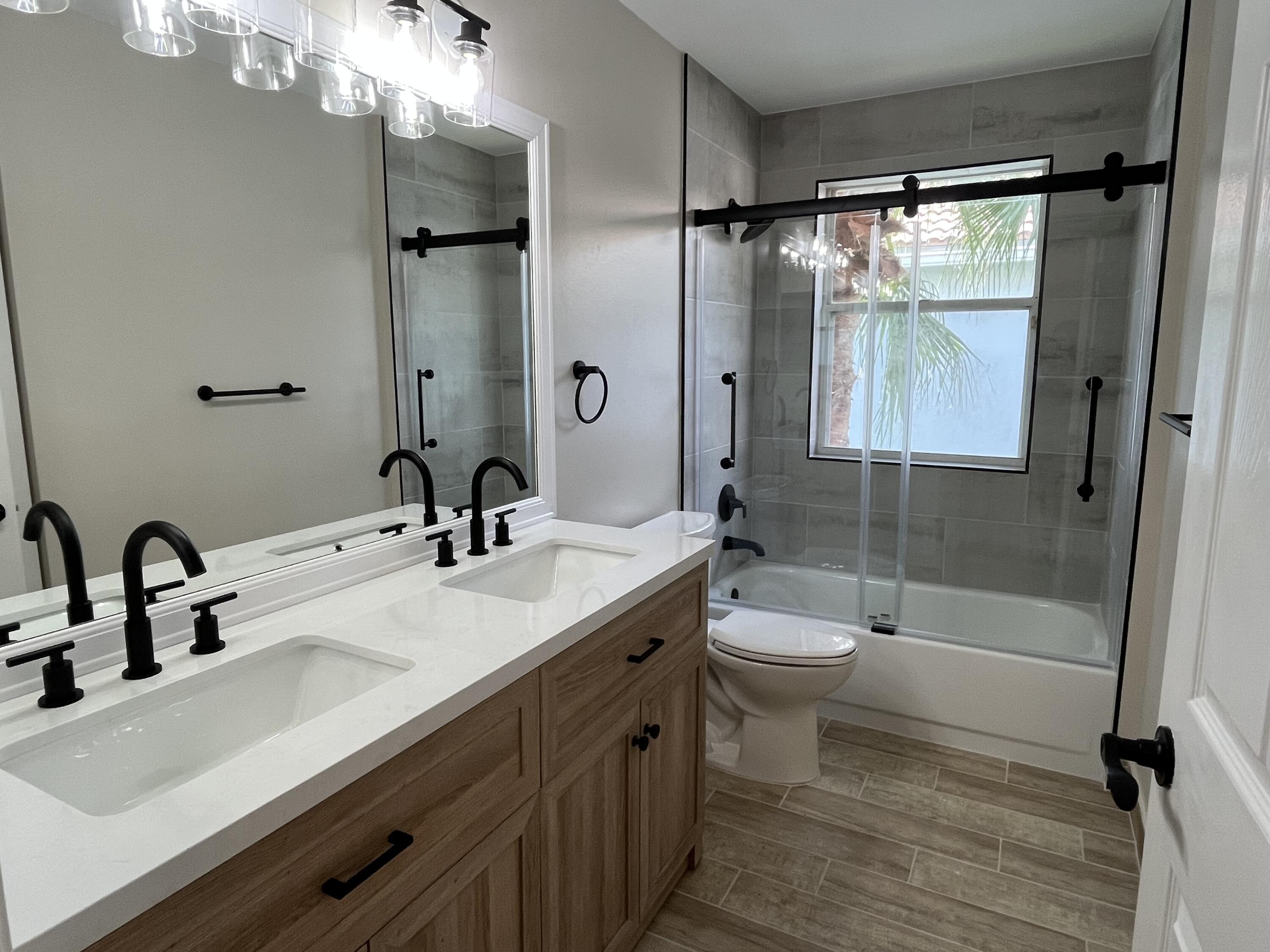 7299 Panache Way Boca Raton, FL 33433 - Photo 13 of 16 a bathroom with a double vanity sink toilet and shower