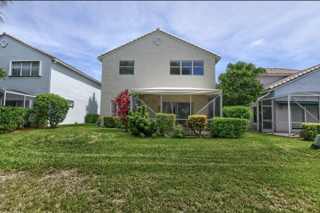 7299 Panache Way Boca Raton, FL 33433 - Photo 16 of 16 a front view of a house with a yard and garage