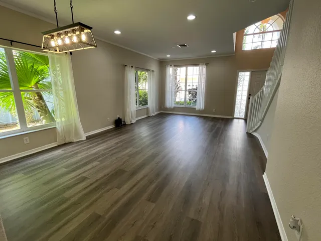 a view of livingroom with window wooden floor and front door