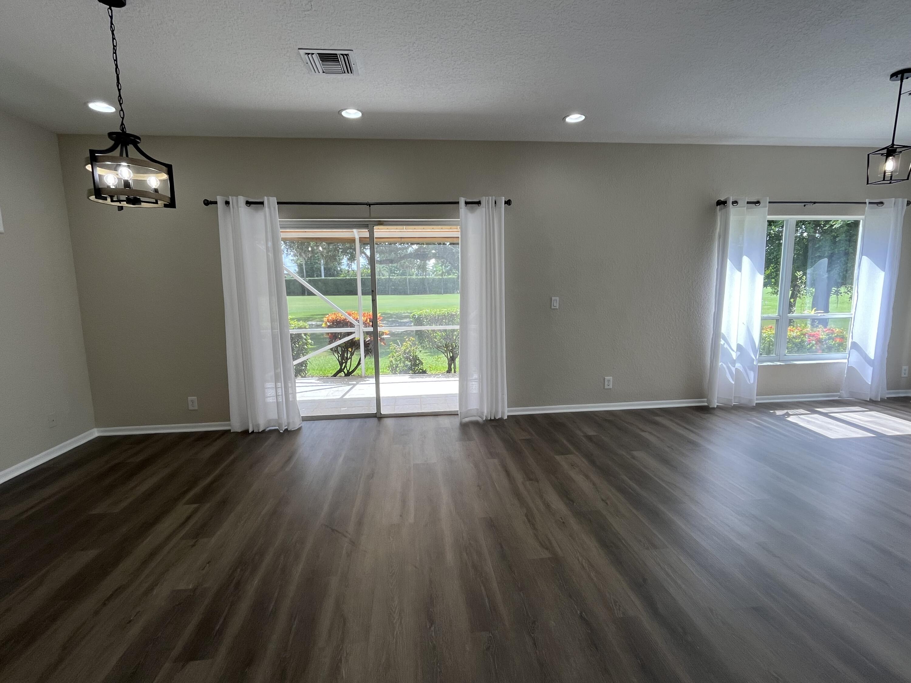 7299 Panache Way Boca Raton, FL 33433 - Photo 5 of 16 wooden floor in an empty room with a window